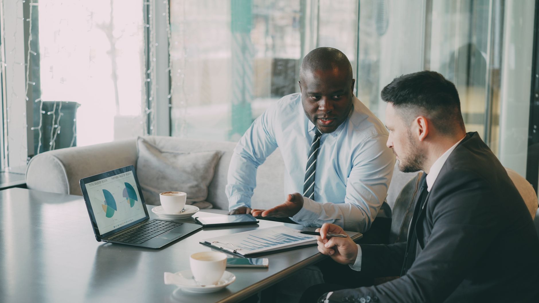 Two businessmen discussing data at a cafe while enjoying coffee. — LLC, Is It The Ideal Choice? The What, When, And How Come