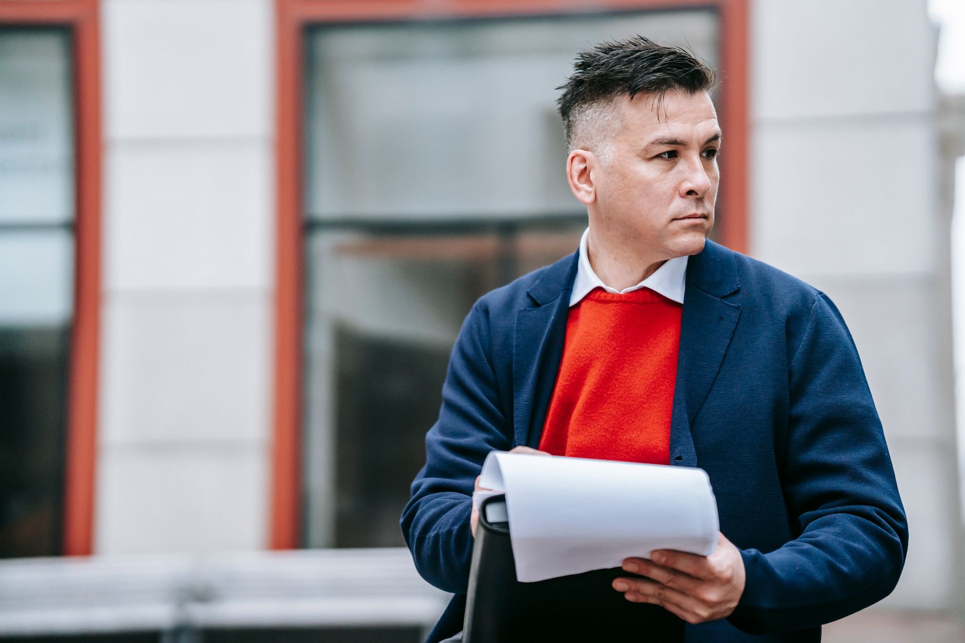 A serious man holding papers, dressed professionally in an urban environment. — Top Features Of Shortstack