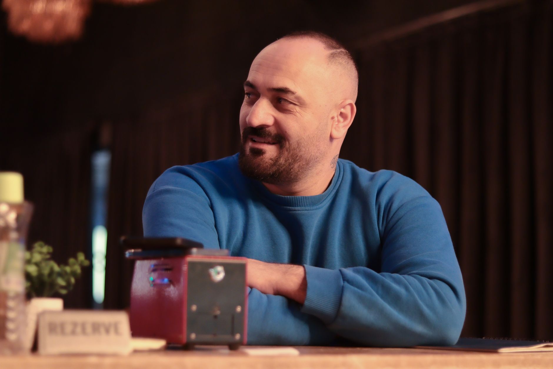 Casual portrait of a man in a blue sweater sitting indoors at a restaurant. — UNT HSC Fort Worth: A Premier Destination for H
