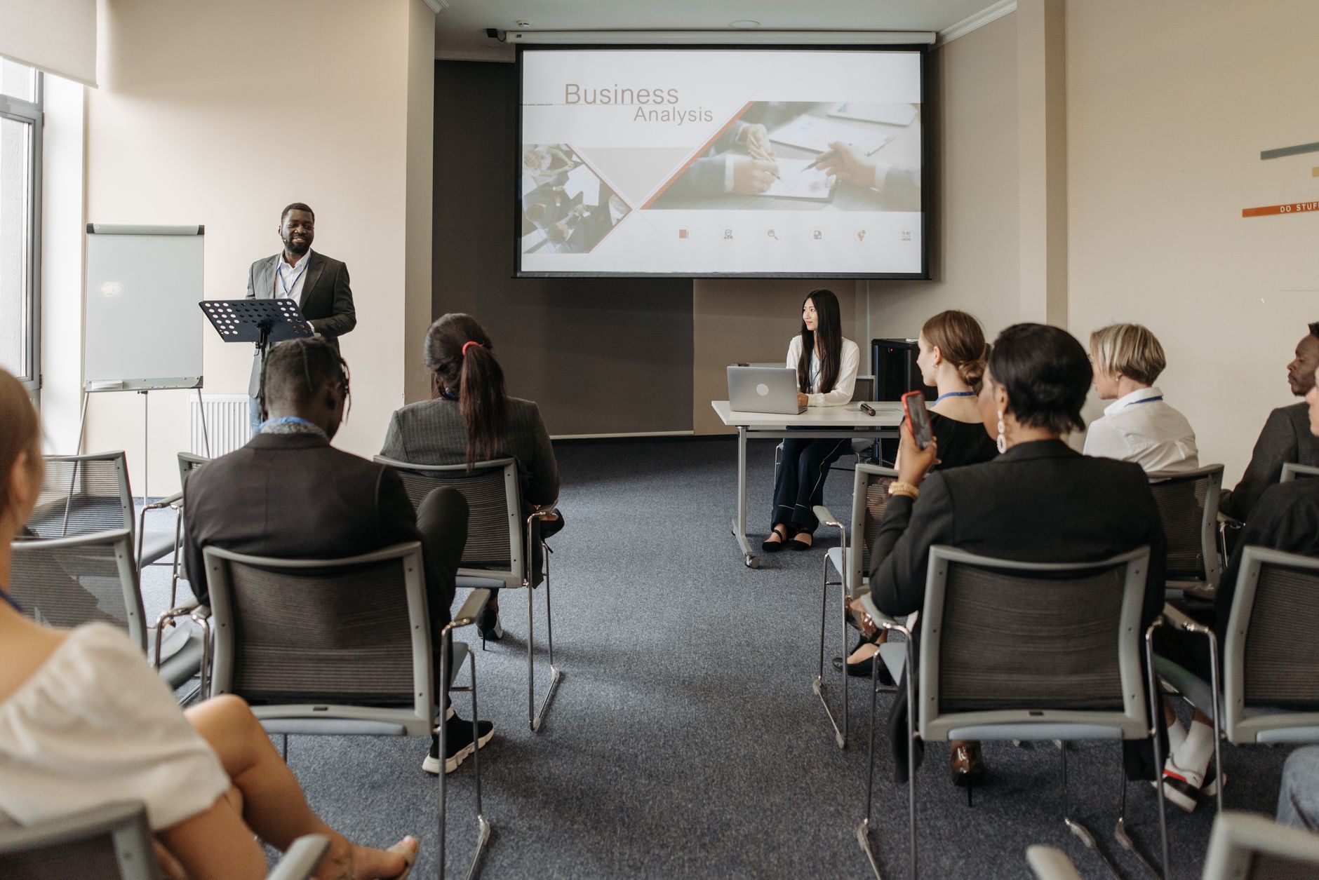 A diverse group of adults attending a presentation in a conference room setting. — Why floor polishing and cleaning is import
